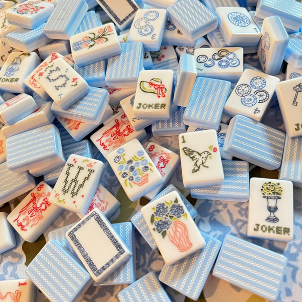 Collection of colorful mahjong tiles with various designs and 'Joker' tiles.