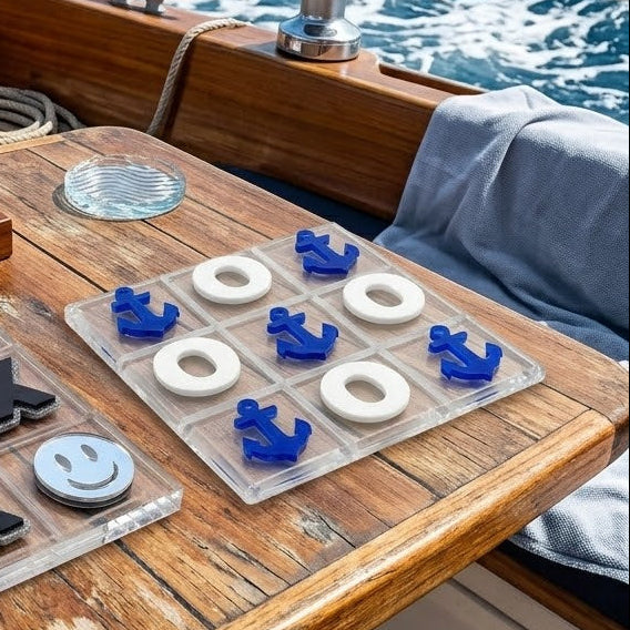 Noughts and crosses game on a wooden table with ocean view