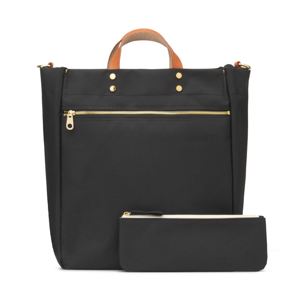 A black tote bag with a top handle, gold-tone hardware, and a matching zip pouch placed in front, photographed on a clean white background.