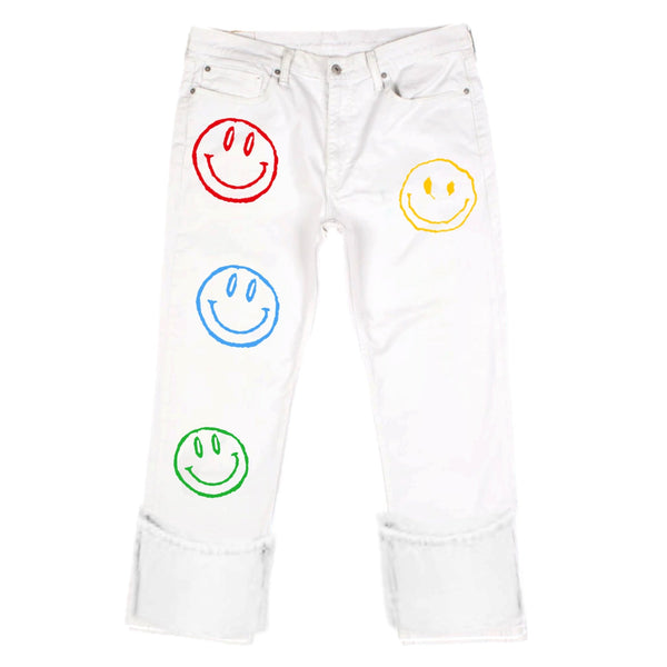 White jeans with colorful smiley face designs on a white background
