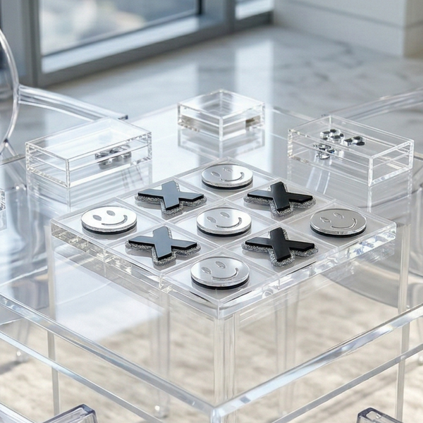 Clear acrylic table with chairs in a modern room with large windows.