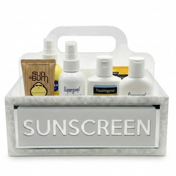 Caddy with sunscreen bottles and supplies on a white background