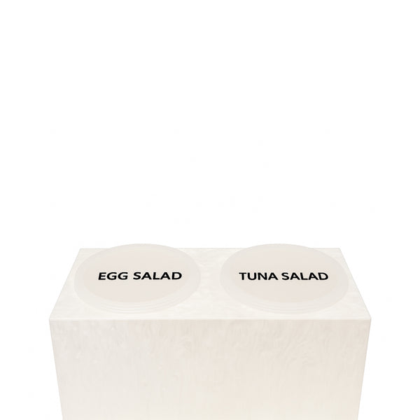 White two-compartment acrylic salad holder with lids labeled Egg Salad and Tuna Salad.