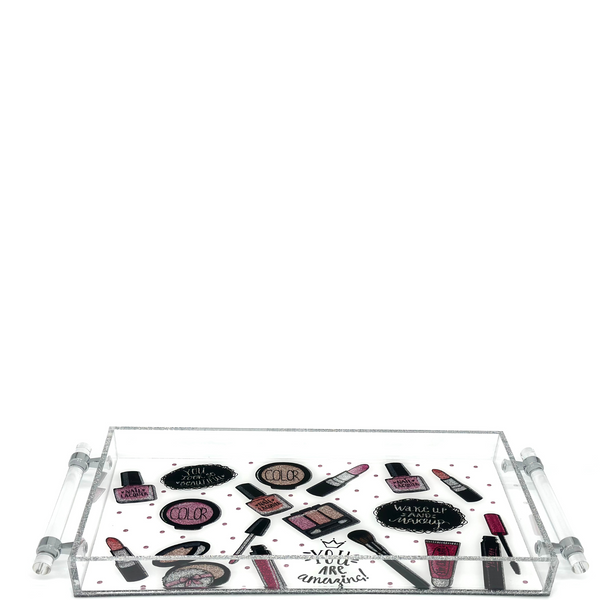 Top view of an acrylic tray with a pink and black makeup-item print.
