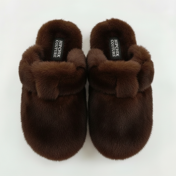 Top view of a pair of chocolate brown fur clogs with closed toes and adjustable straps.