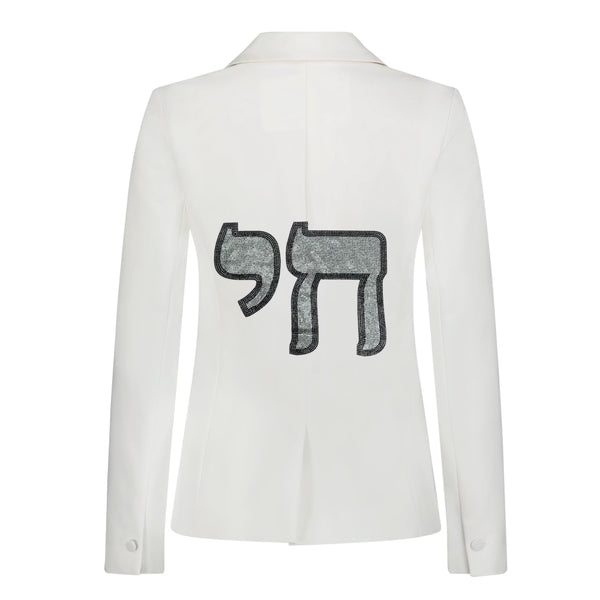 Back view of a white denim blazer with a silver crystal Chai symbol outlined in black.
