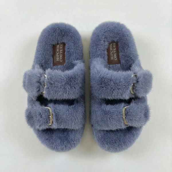 Top view of denim blue mink fur slide sandals with two buckled straps and open toes.