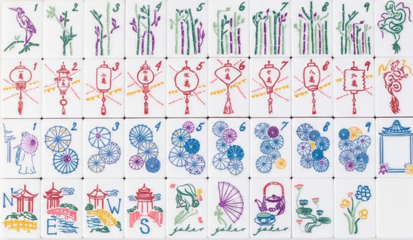A set of white rectangular tiles with colorful printed illustrations arranged in a grid on a white background. The tiles feature various drawings including birds, bamboo, lanterns, flowers, wheels, and architectural motifs, with some tiles showing the word 'joker' printed in green script.
