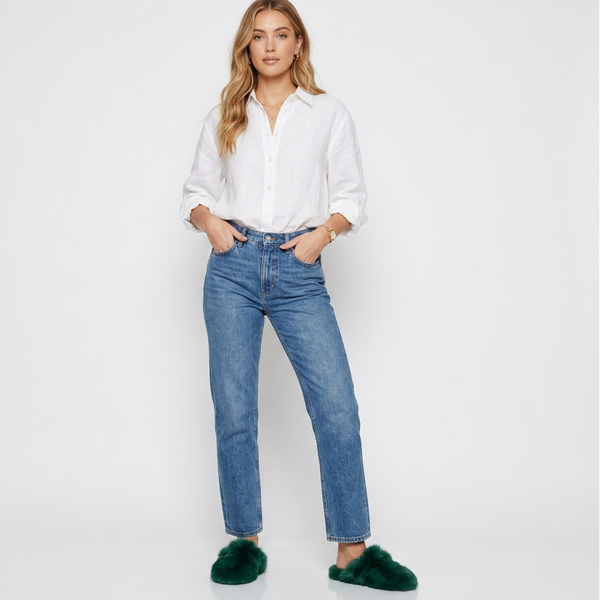 Woman wearing a white shirt and blue jeans on a white background