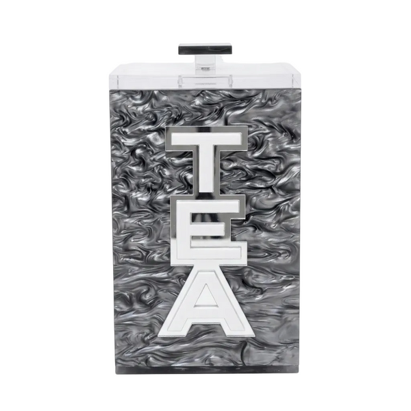 Tea canister with marbled design and 'TEA' letters on a white background