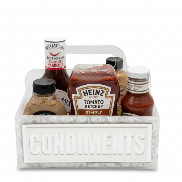 Set of condiment bottles in a white carrying case with 'CONDIMENTS' label on a white background