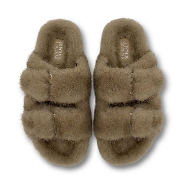 Pair of fluffy brown slippers on a white background