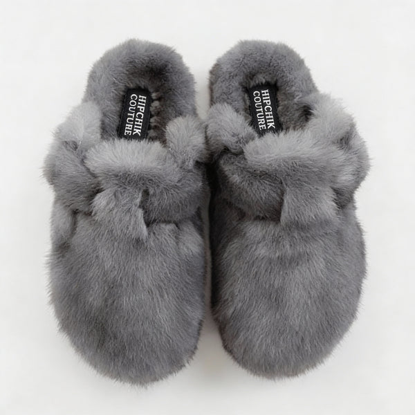 Top view of gray fur clogs showing their closed toes, plush lining and adjustable straps.