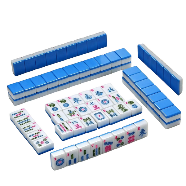 A set of Mahjong tiles arranged on a light beige surface, showing both the blue-backed tiles and the white front faces with colorful Chinese characters and symbols.