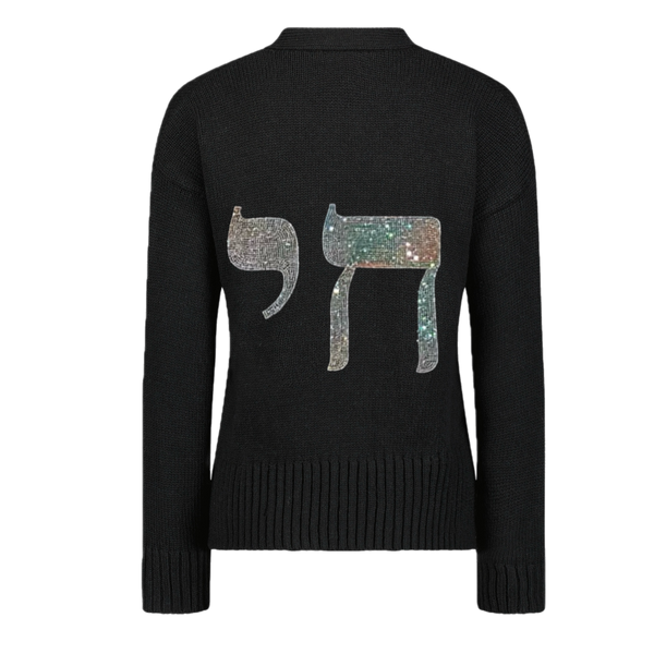 Back view of a black knit sweater with a large silver rhinestone Chai symbol.