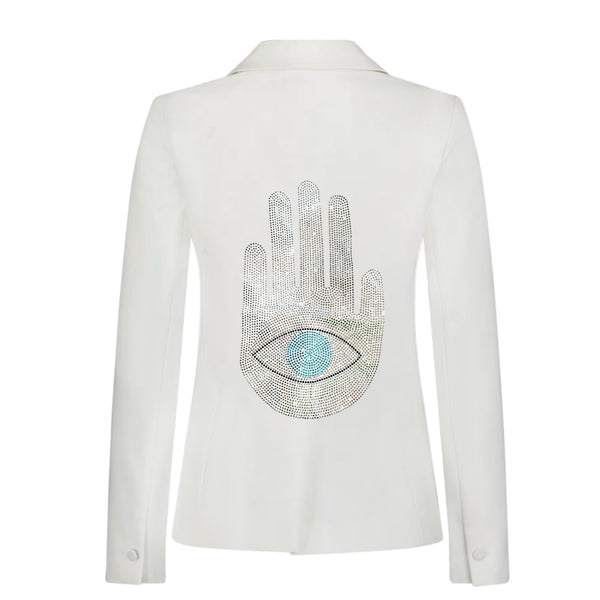 Back view of a white denim blazer with a silver rhinestone Hamsa hand and turquoise eye.
