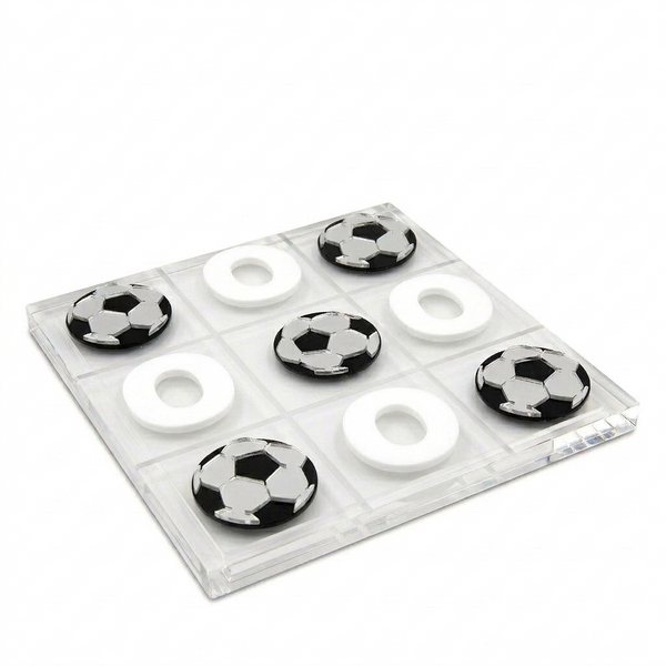 Set of black and white soccer ball-shaped candies in a clear plastic packaging on a white background