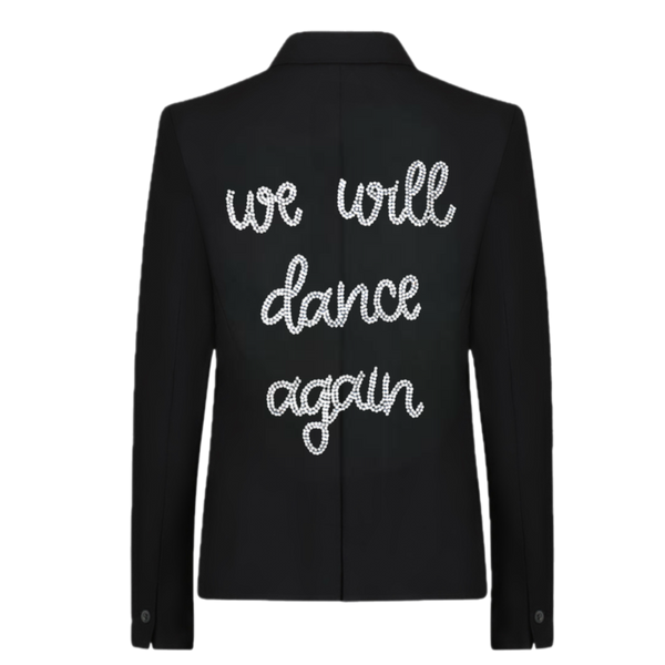 Back view of a black blazer with silver rhinestone we will dance again lettering.