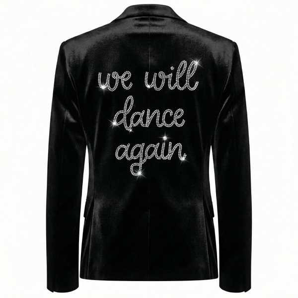 Back view of a black velvet blazer with silver rhinestone we will dance again lettering.