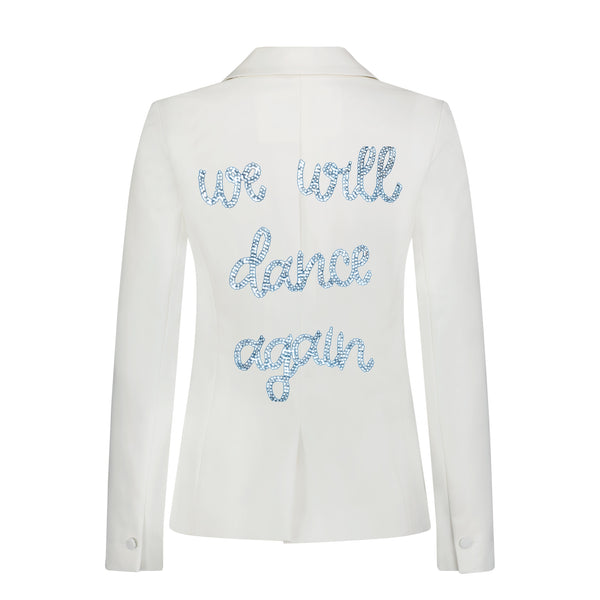 Back view of a white denim blazer with pale blue rhinestone we will dance again lettering.