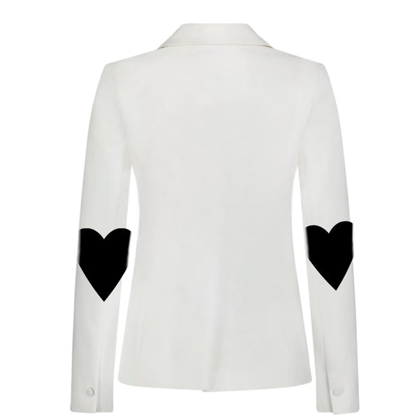 Back view of a white denim blazer with black hearts on both elbows.